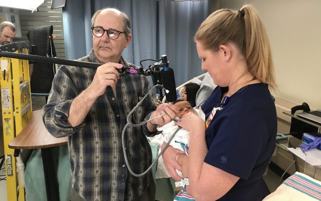 Audio technician adjusting mic on medical set